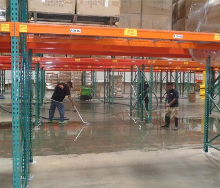 SERVPRO techs and water removal equipment in warehouse