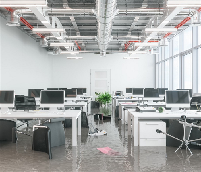 a flooded office with chairs and furniture on the ground