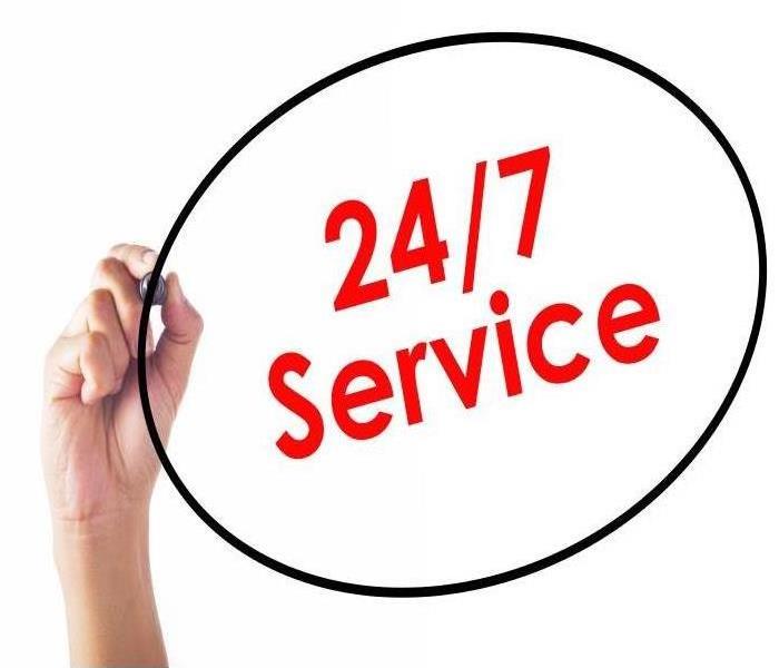 Hand circling 24/7 Service red wording with a black marker